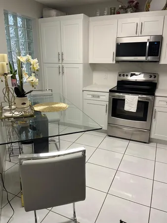 a kitchen with white cabinets and a sink