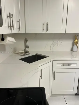 a kitchen with a sink and cabinets