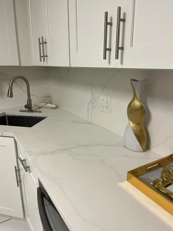 a kitchen with a stove and a white cabinets