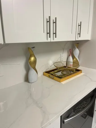a kitchen with a sink a stove and chairs