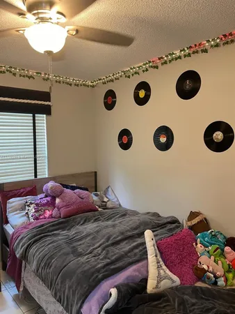 a bedroom with a bed and flat screen tv