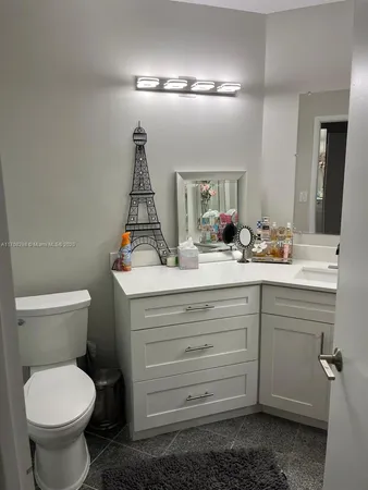 a bathroom with a sink mirror and toilet