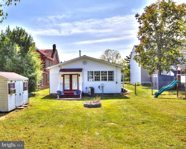a view of a house with pool and a yard