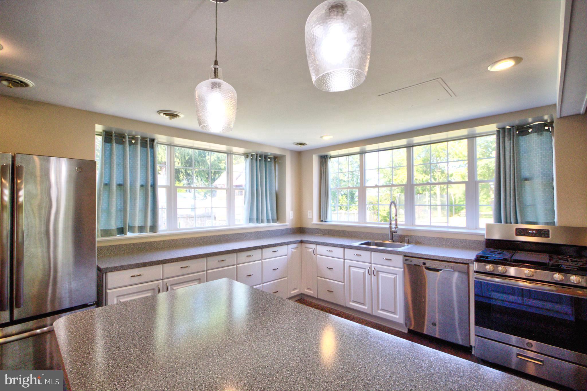 6200 Middleburg Road Keymar, MD 21757 - Photo 4 of 18 a large kitchen with kitchen island a large window cabinets and stainless steel appliances