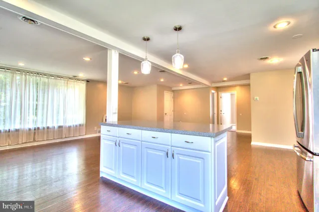 a bathroom with a large mirror vanity and shower