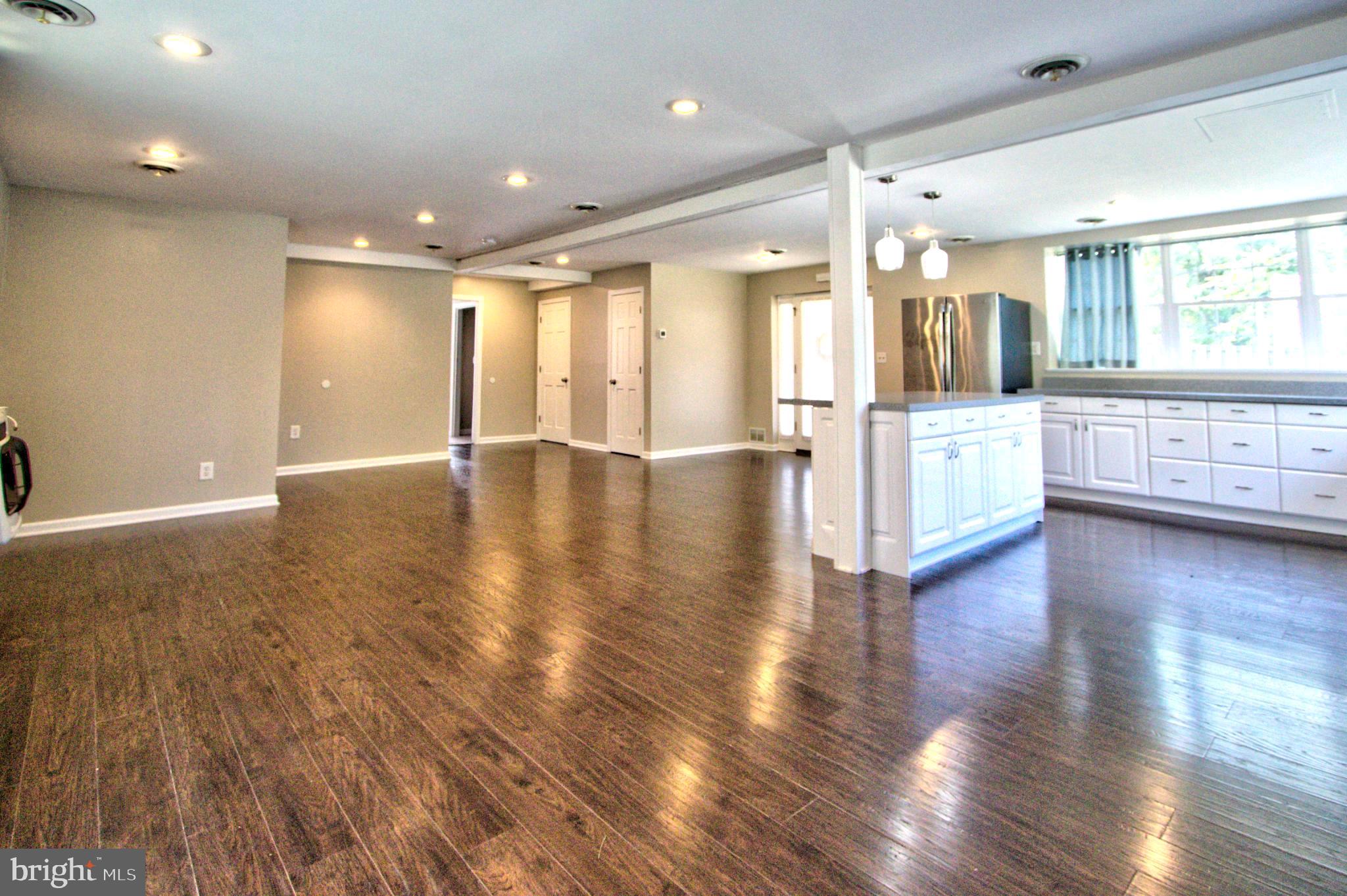 6200 Middleburg Road Keymar, MD 21757 - Photo 9 of 18 a view of an empty room with wooden floor and a kitchen