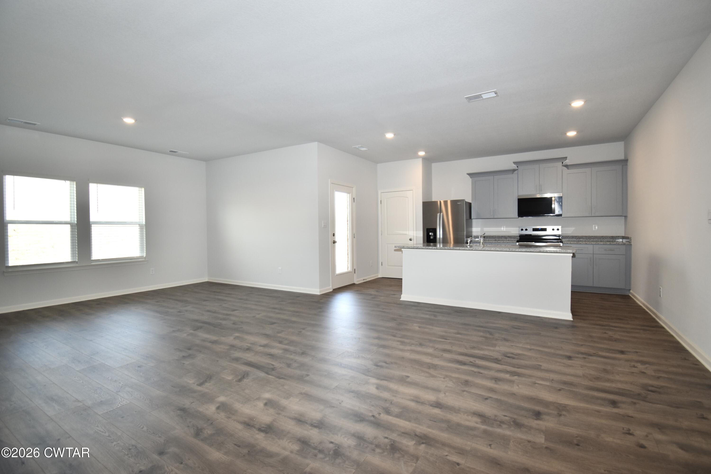 71 Clarendon Cove Jackson, TN 38305 - Photo 3 of 18 a view of kitchen with microwave a refrigerator and a stove top oven