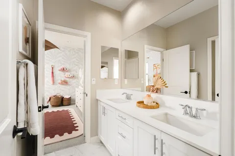 a en suite bathroom with a granite countertop sink and a mirror a bathtub