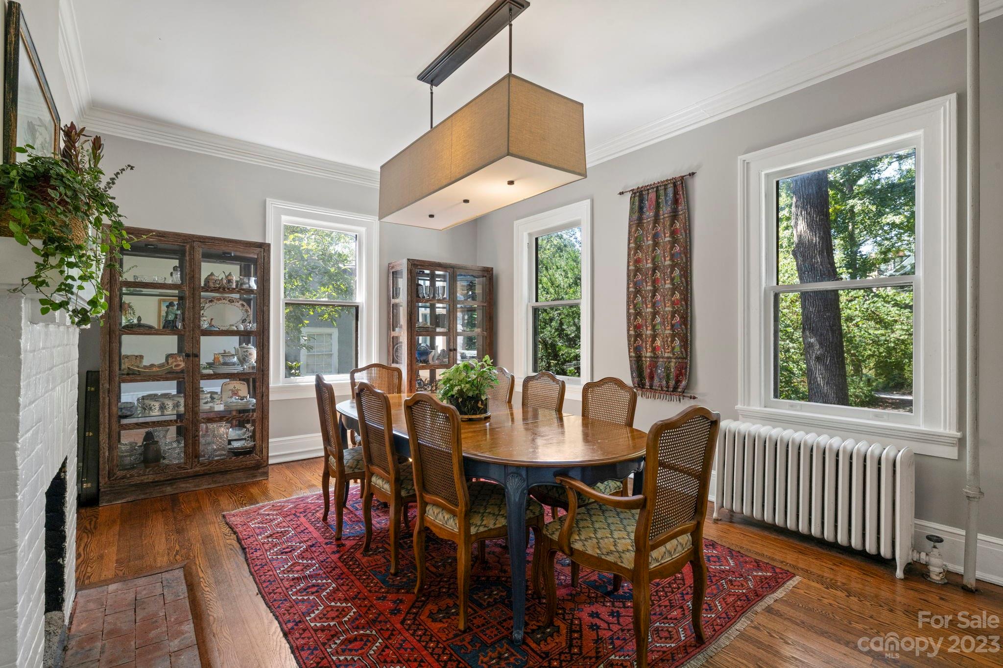 18 Cherokee Road Asheville, NC 28801 - Photo 17 of 45 a dining room with wooden floor a chandelier a glass table and chairs