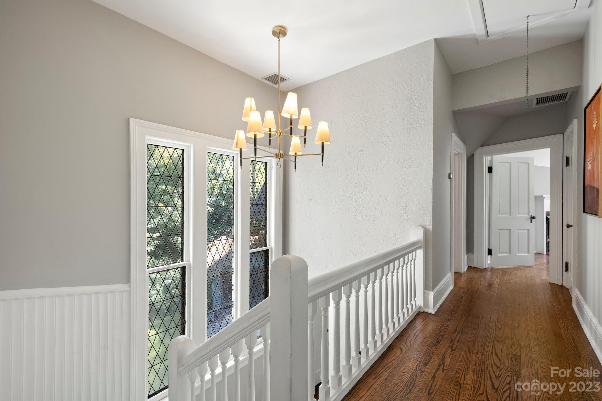 18 Cherokee Road Asheville, NC 28801 - Photo 23 of 45 a view of a hallway with wooden floor and stairs