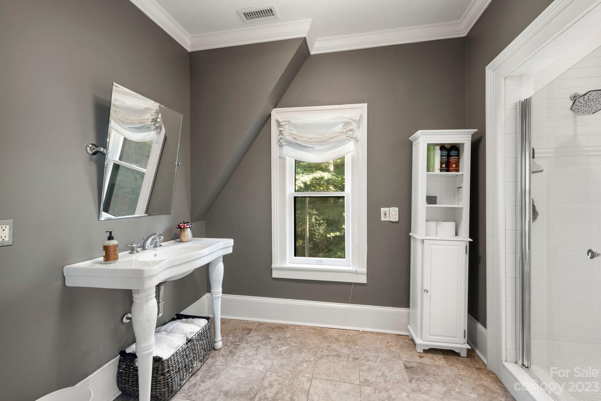 18 Cherokee Road Asheville, NC 28801 - Photo 30 of 45 a bathroom with a sink and a mirror