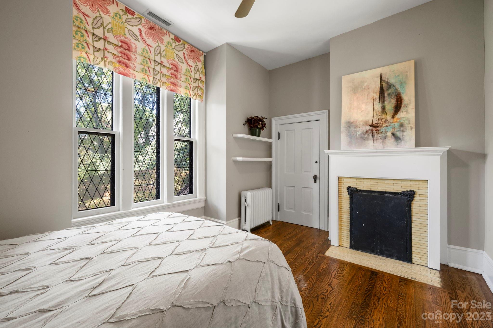 18 Cherokee Road Asheville, NC 28801 - Photo 32 of 45 a bedroom with a bed and a fireplace
