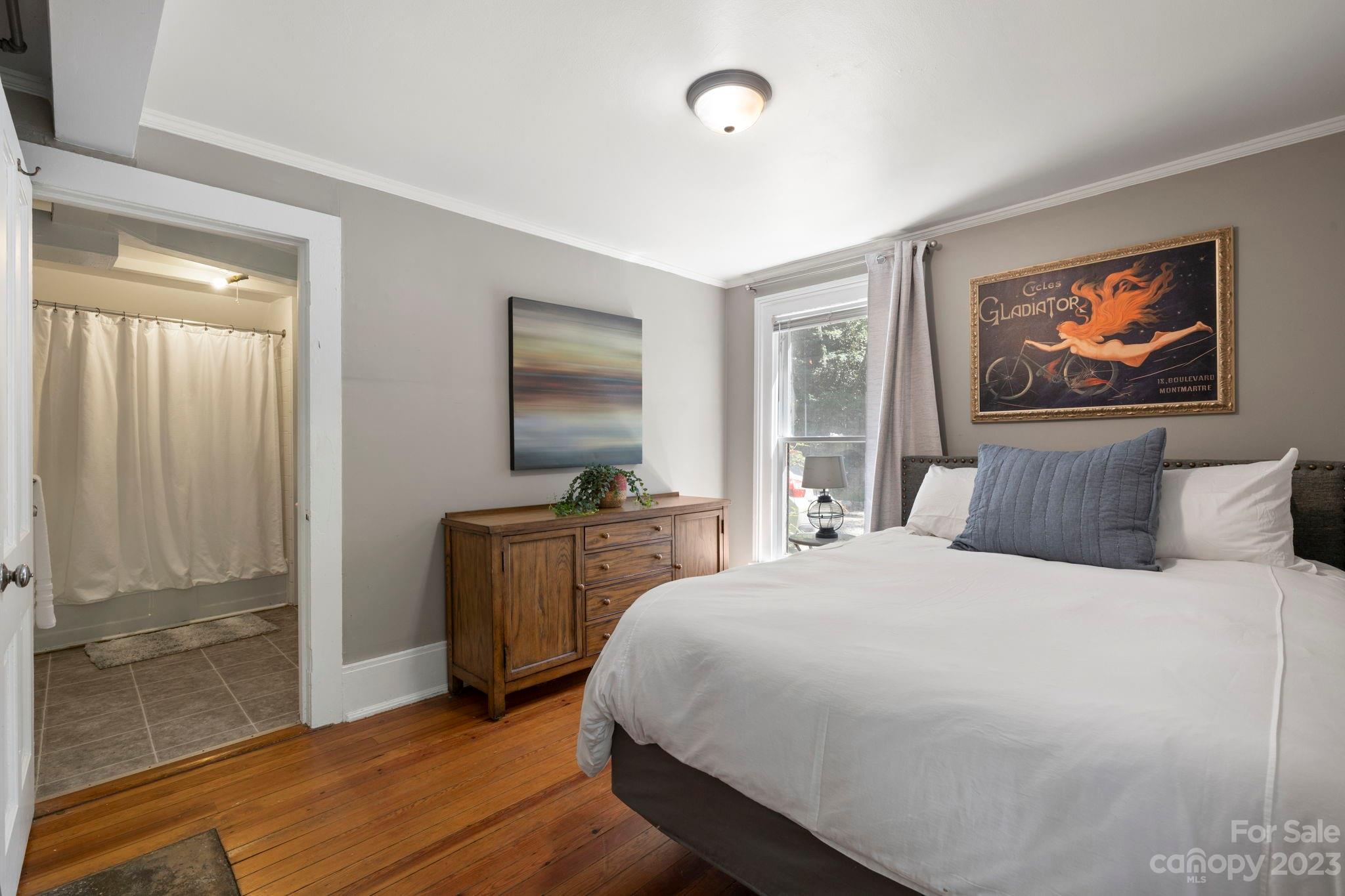 18 Cherokee Road Asheville, NC 28801 - Photo 35 of 45 a bedroom with a bed and a flat screen tv