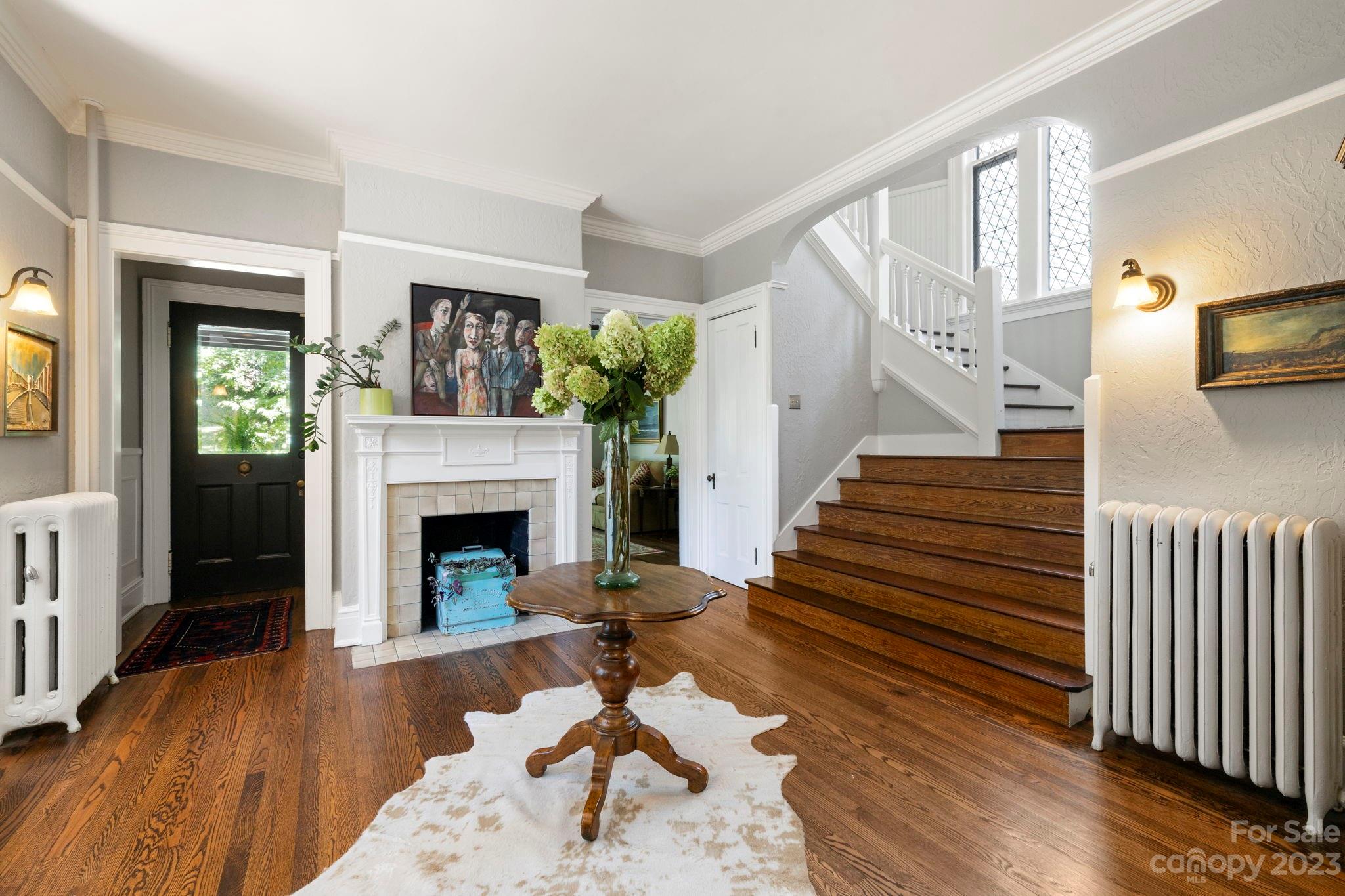 18 Cherokee Road Asheville, NC 28801 - Photo 10 of 45 a living room with wooden floors and a fireplace