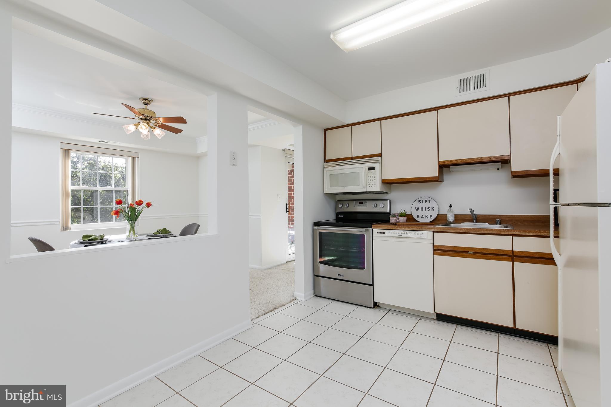 102 Castletown Road, Unit 302 Lutherville-Timonium, MD 21093 - Photo 5 of 16 Kitchen opens nicely to dining area