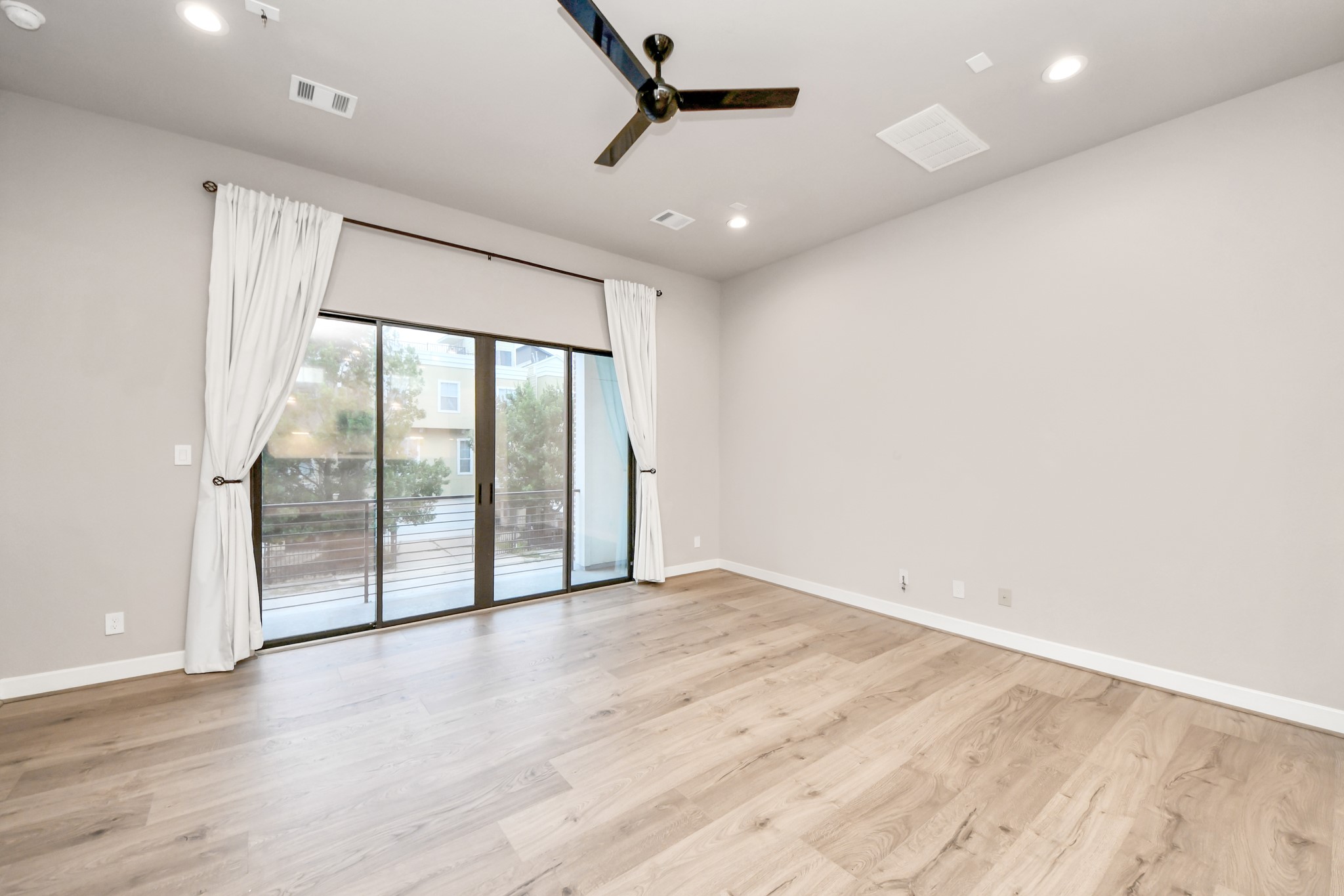 2114 Stuart Street Houston, TX 77004 - Photo 22 of 39 an empty room with wooden floor and windows
