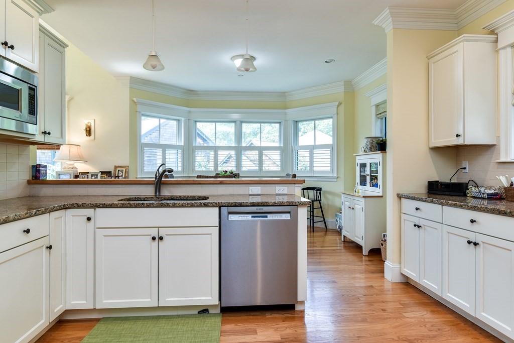 7 Hawthorne Lane, Unit 7 Dover, MA 02030 - Photo 11 of 30 a kitchen with stainless steel appliances granite countertop a stove a sink and a microwave