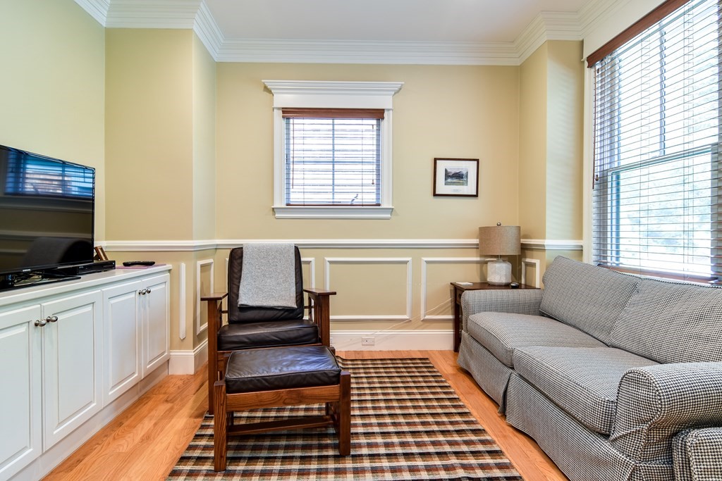 7 Hawthorne Lane, Unit 7 Dover, MA 02030 - Photo 13 of 30 a living room with a couch and a flat screen tv