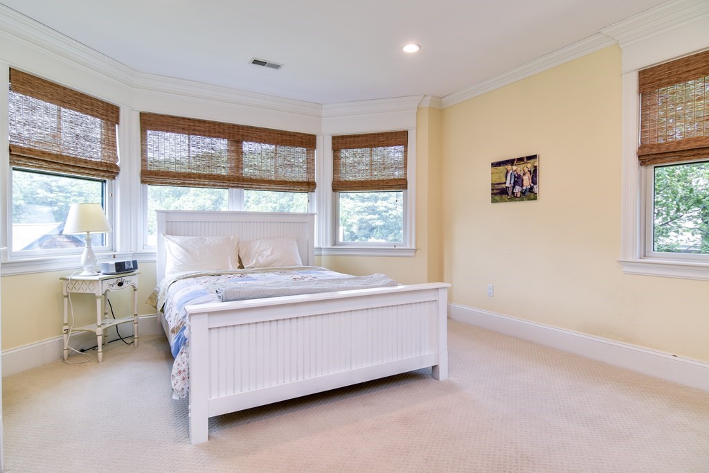 7 Hawthorne Lane, Unit 7 Dover, MA 02030 - Photo 21 of 30 a spacious bedroom with a bed and a large window
