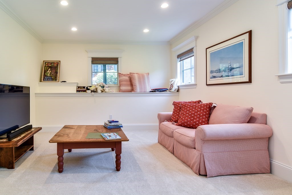 7 Hawthorne Lane, Unit 7 Dover, MA 02030 - Photo 24 of 30 a living room with furniture a rug and a flat screen tv