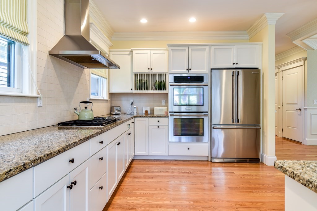 7 Hawthorne Lane, Unit 7 Dover, MA 02030 - Photo 9 of 30 a kitchen with granite countertop a refrigerator oven a sink and white cabinets