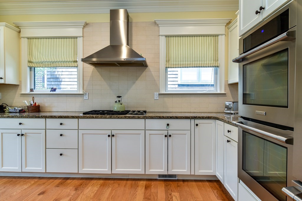 7 Hawthorne Lane, Unit 7 Dover, MA 02030 - Photo 10 of 30 a kitchen with granite countertop a sink a stove and cabinets
