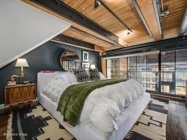 a bed sitting in a bedroom next to a window