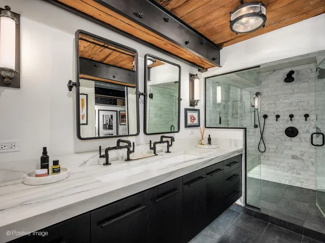 a bathroom with a double vanity sink mirror and bathtub
