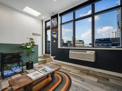 a bedroom with a bed table and a flat screen tv