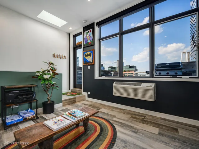 a bedroom with a bed table and a flat screen tv
