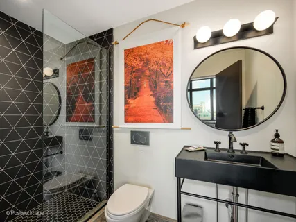 a bathroom with a sink a toilet and a mirror