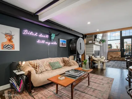 a living room with furniture and a floor to ceiling window