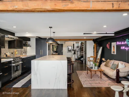 a kitchen with stainless steel appliances granite countertop a stove top oven a sink a counter top space and cabinets