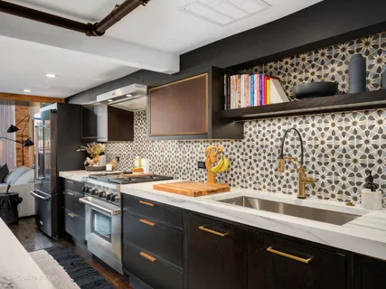 a kitchen with stainless steel appliances a sink dishwasher a stove and a microwave oven