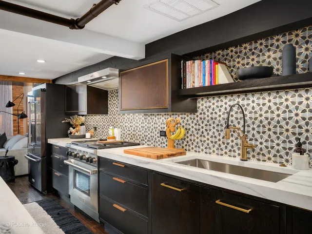 a kitchen with stainless steel appliances a sink dishwasher a stove and a microwave oven