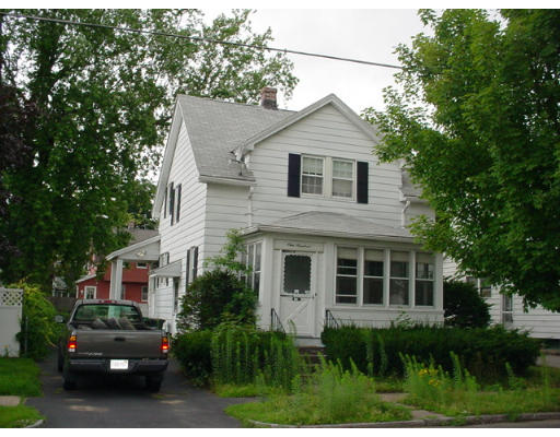 100 Wilber Street Springfield, MA 01104 - Photo 1 of 9 a view of a yard in front of a house with plants and large trees