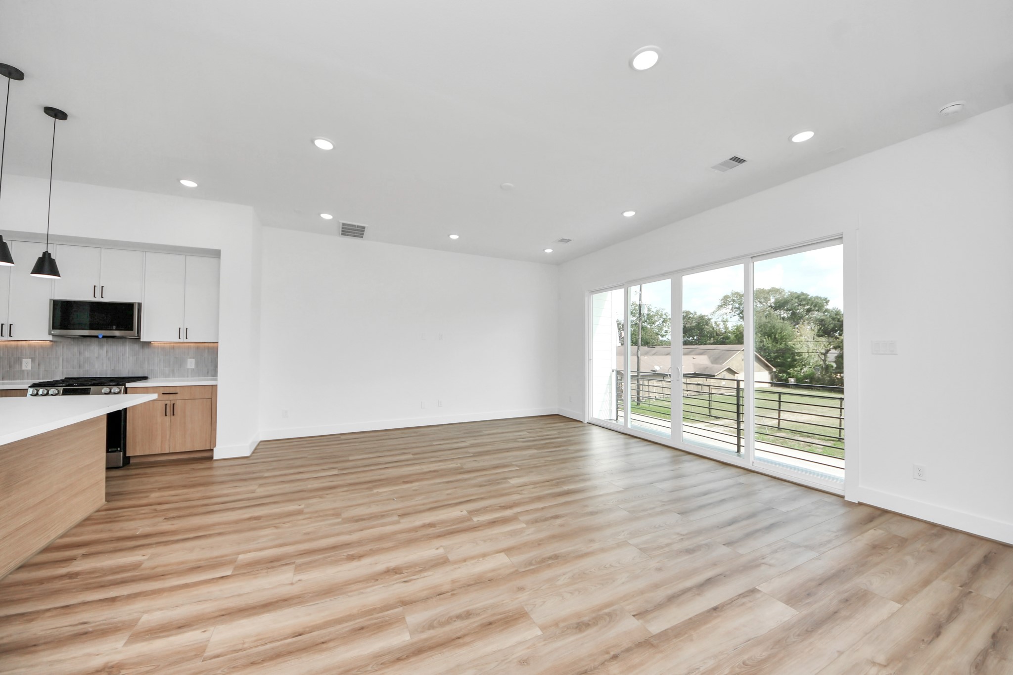 6949 Foster Street Houston, TX 77021 - Photo 15 of 40 a view of an empty room with wooden floor and a window
