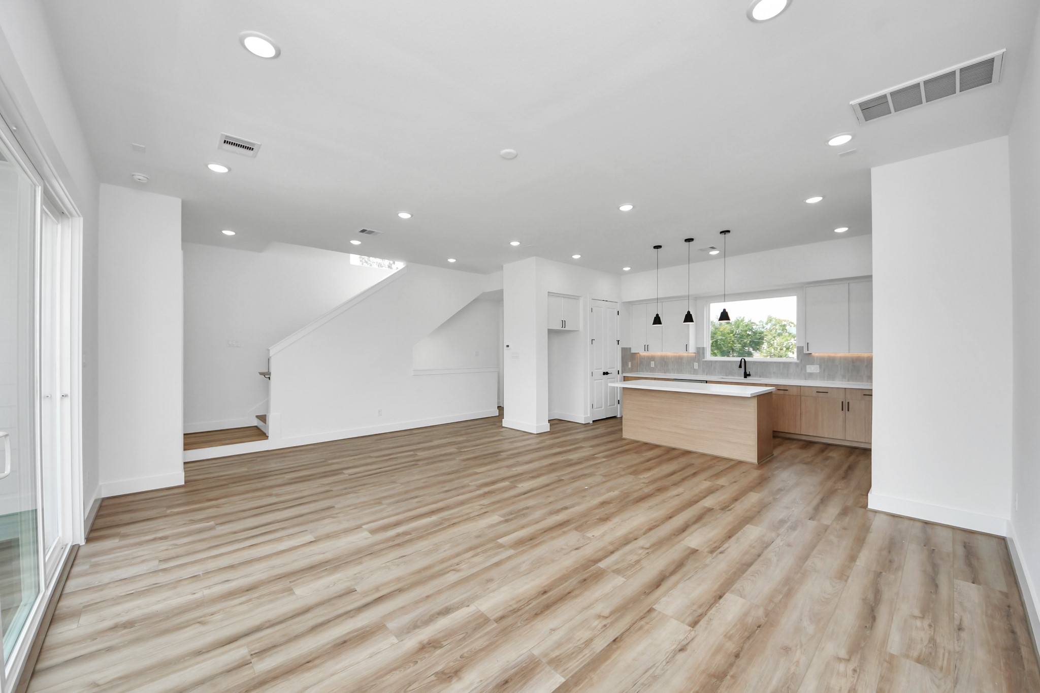 6949 Foster Street Houston, TX 77021 - Photo 17 of 40 a view of a kitchen with kitchen island a sink stainless steel appliances and cabinets
