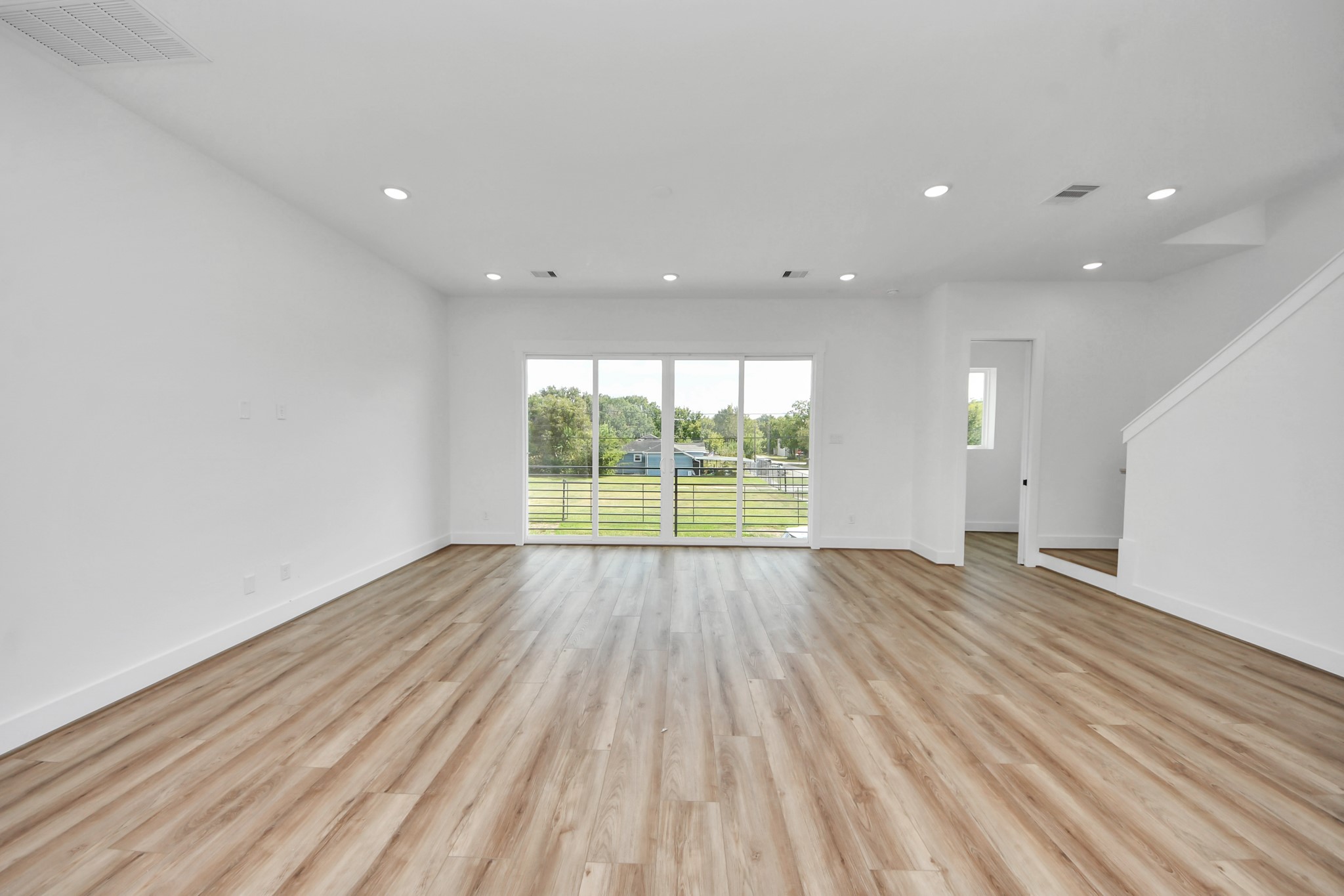 6949 Foster Street Houston, TX 77021 - Photo 18 of 40 an empty room with wooden floor and outdoor view