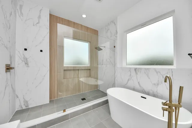 a bathroom with a tub shower and sink