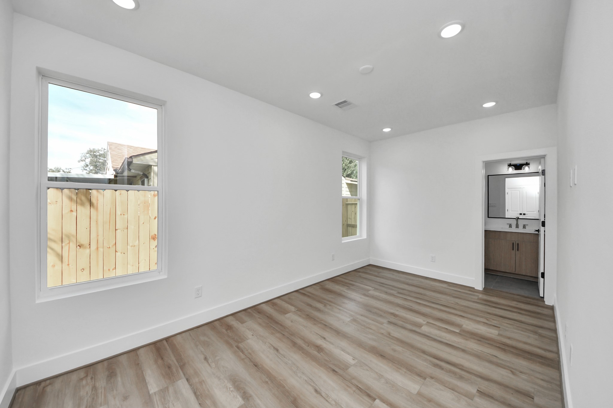 6949 Foster Street Houston, TX 77021 - Photo 6 of 40 a view of empty room with wooden floor and fan