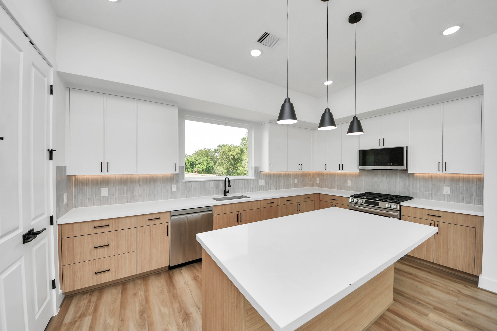 6949 Foster Street Houston, TX 77021 - Photo 10 of 40 a kitchen with a sink a stove and a refrigerator