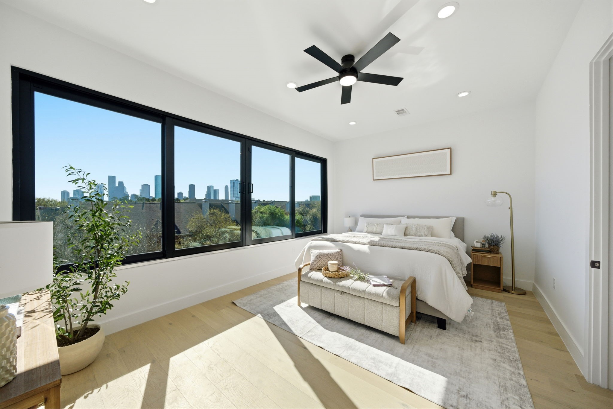 809 Memorial Heights Drive Houston, TX 77007 - Photo 2 of 40 a spacious bedroom with a large bed and a large window
