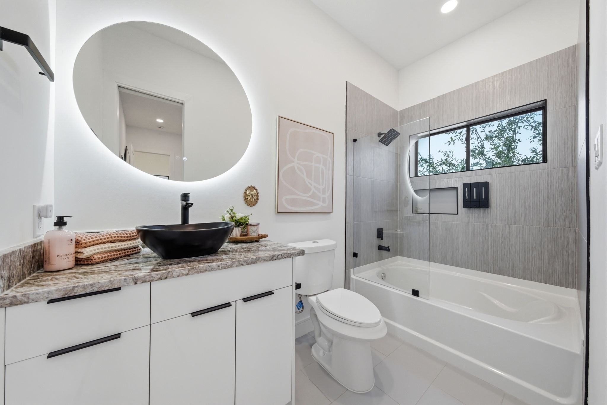 809 Memorial Heights Drive Houston, TX 77007 - Photo 32 of 40 a bathroom with a granite countertop toilet a sink and a mirror