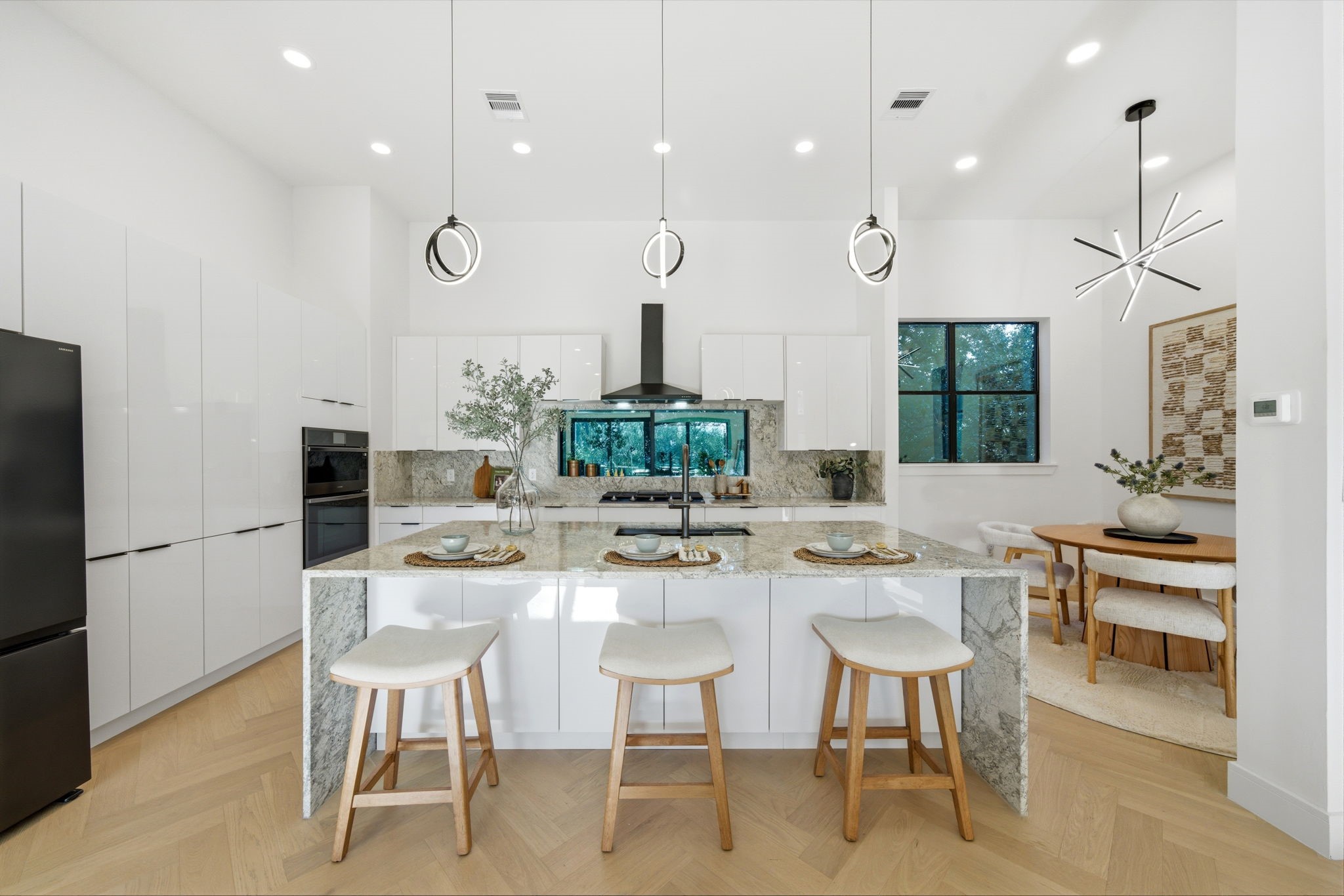 809 Memorial Heights Drive Houston, TX 77007 - Photo 6 of 40 a kitchen with kitchen island stainless steel appliances a dining table and chairs
