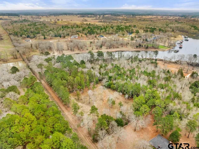 an aerial view of mountains with green space and fog