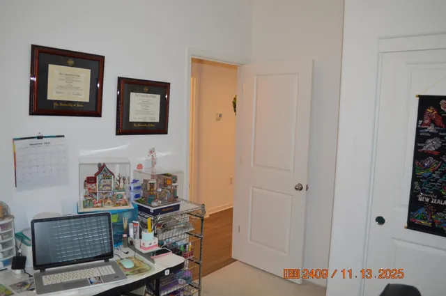 a room with lots of books and a painting on the wall