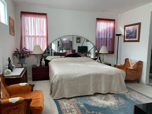 a bedroom with a bed and wooden furniture