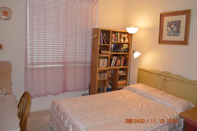a bedroom with a bed and book shelf