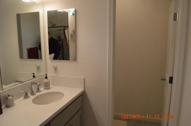 a bathroom with a sink and a mirror